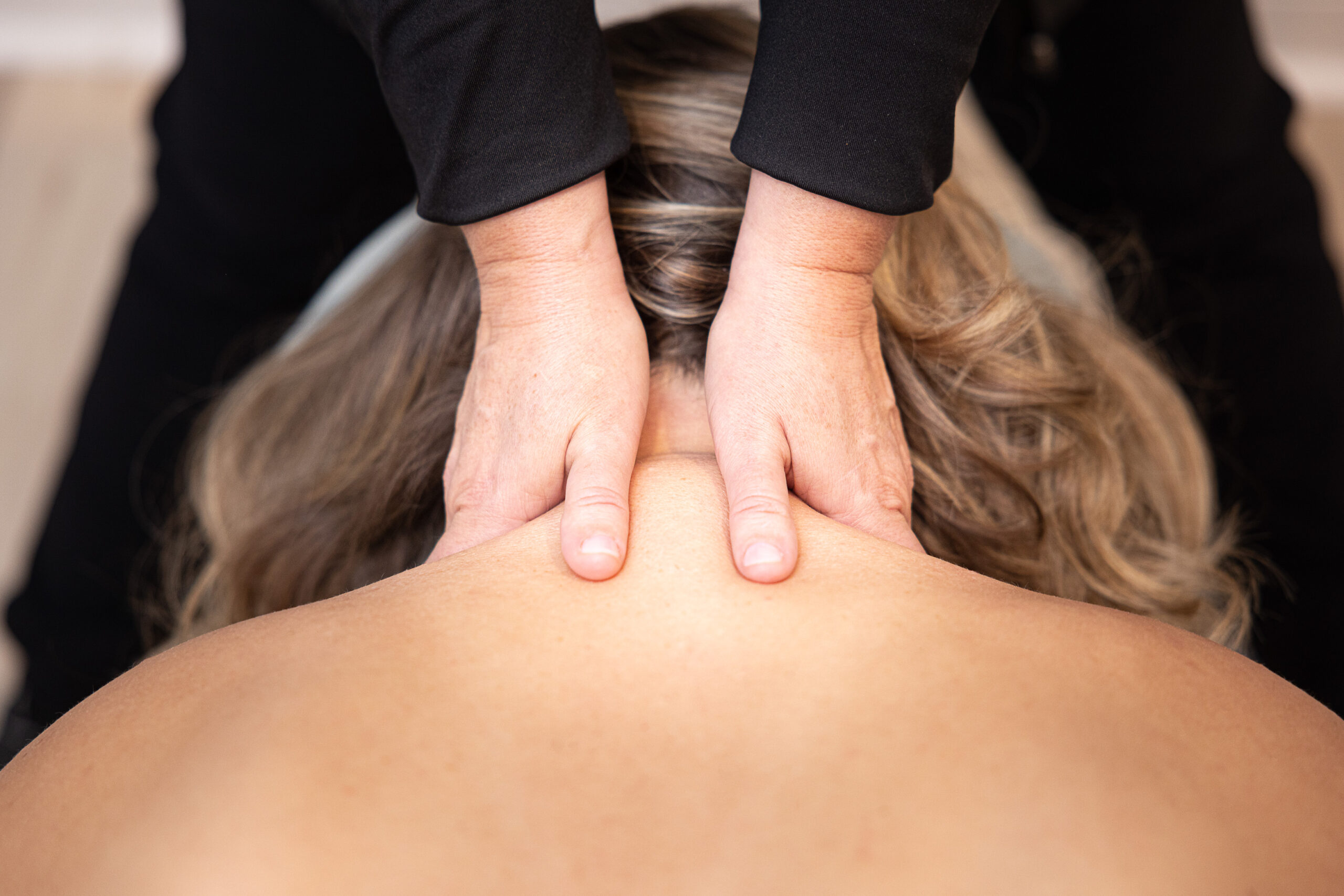 Massage therapist performing a shoulder massage at Whole Body Massage and Pilates in Knoxville